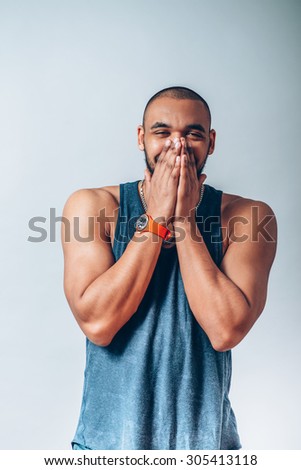 black man laughs and covers her mouth