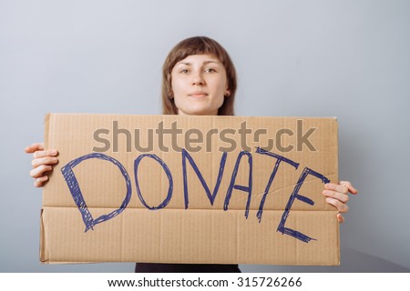 Woman with cardboard sign, donation. On a gray background.