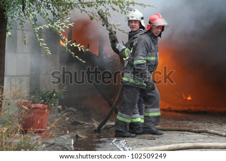 KHMELNITSKY, UKRAINE - OCTOBER 11: fire department in action during burning warehouses with plastic products, October 11, 2011 in Khmelnitsky, Ukraine
