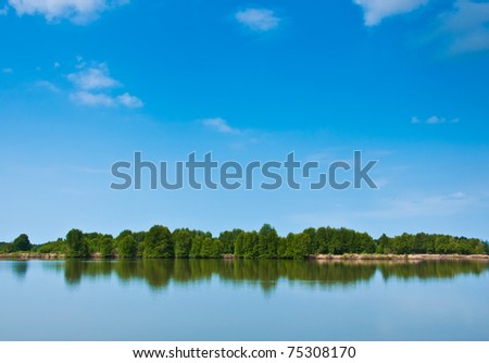 Summer forest river with reflection of the sky