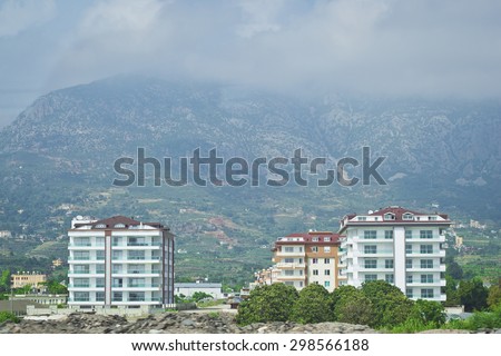 At the foot of the mountains. Tenement house in the village of Kemer, standing at the foot of the mountains