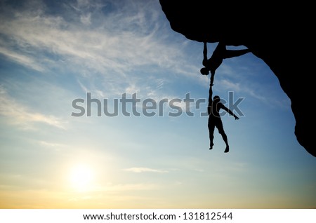 climber on the mountain holding another