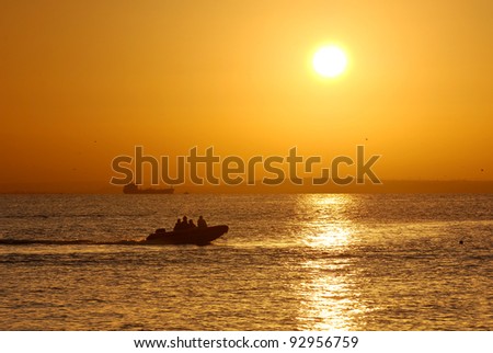 People on the boat during the golden sunset