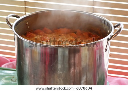 A pot of spicy curry simmering in a metal pot