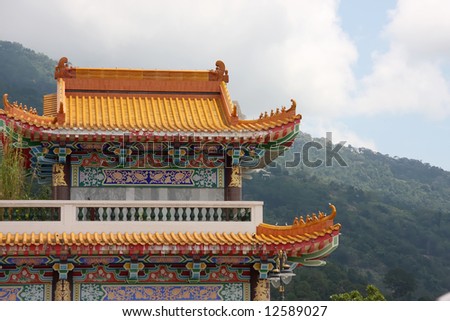 Architectural detail of  traditional chinese temple  rooftop against mountains