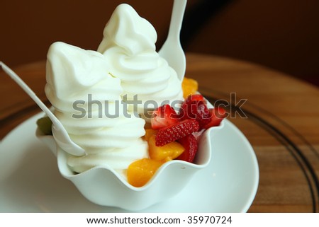 Fancy frozen yoghurt soft serve ice cream with fruits