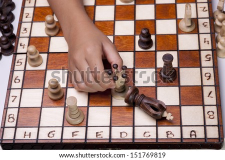 The queen defeating the king in a concept image of a chess game.