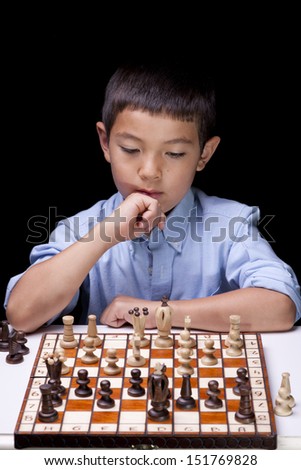 A young boy is deep in thought concentrating on what his next move would be.