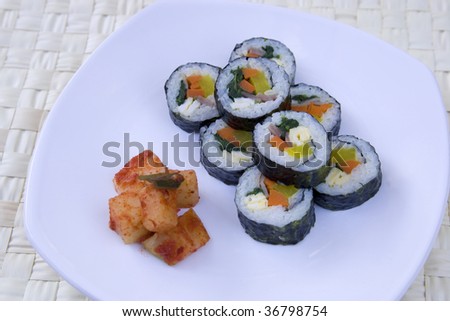 Korean sushi called kimbap and a side of radish kimchi.