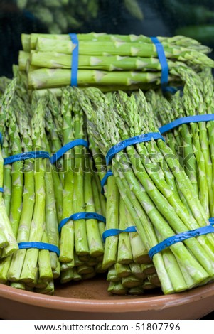 Fresh asparagus spears are banded together for display.