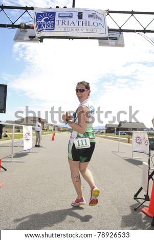 RATHDRUM, IDAHO - JUNE 5: An unidentified runner crosses the finish line after completing the Triathlon June 5, 2011 in Rathdrum, Idaho. Radiant Lake Triathlon is in its infancy on its second year.