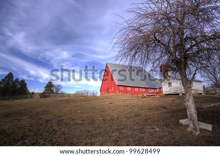 Big barn by field.