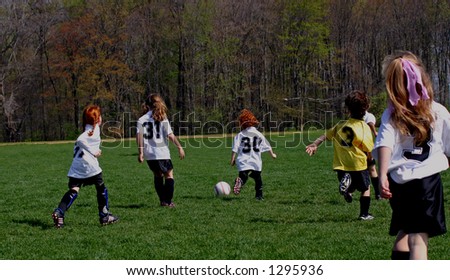 girls youth soccer team playing