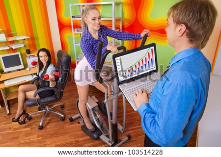 Office portrait of beautiful businesspeople doing exercise at their workplace