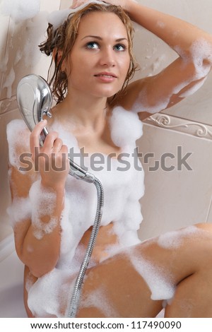 Sensual woman relaxing in bathtub with foam soap sud