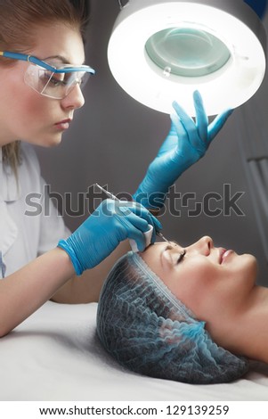 Blackhead cleansing on woman face during facial treatment at beauty clinic