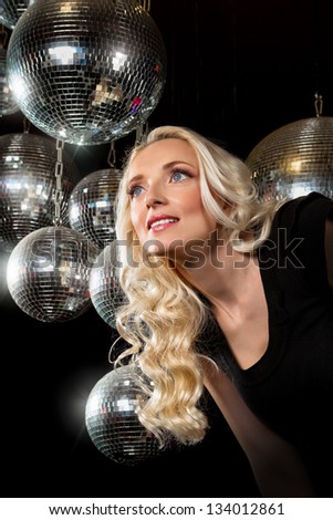 Close-up face of young blonde woman disco mirror ball in hands