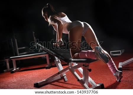 Woman with dumbbells in sport centre