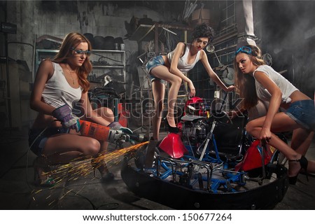 Girls at a garage next to the Go-kart  in smoke