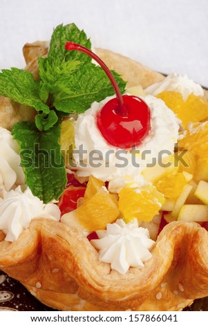 Closeup of fresh baked home made basket cake and maraschino cherry on top isolated on white