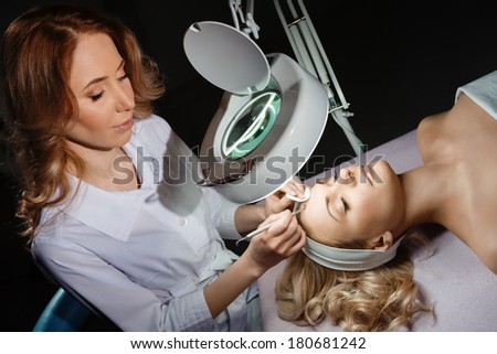 Blackhead cleansing on woman face during facial treatment at beauty clinic
