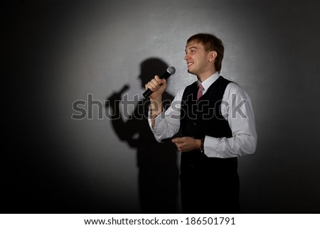 Young handsome guy singing. Jazz musician