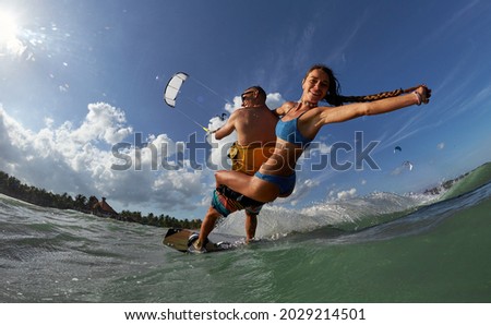 Similar – Image, Stock Photo Female kite surfer riding on board in sea