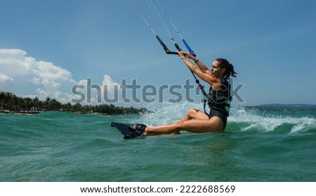 Similar – Image, Stock Photo Female kite surfer riding on board in sea