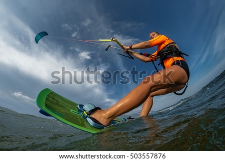 Similar – Image, Stock Photo Female kite surfer riding on board in sea