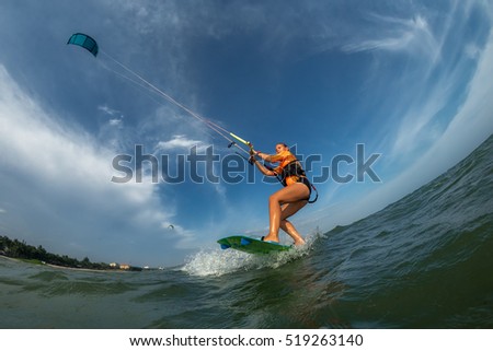 Image, Stock Photo Female kite surfer riding on board in sea