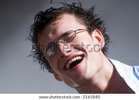 Portrait of laughing man with wet glasses