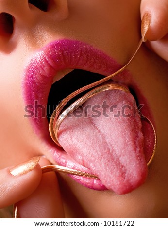 Girl bending silver necklace around tongue