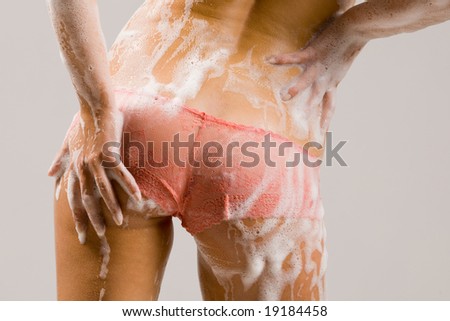 Beautiful young  lady topless with soap foam on body