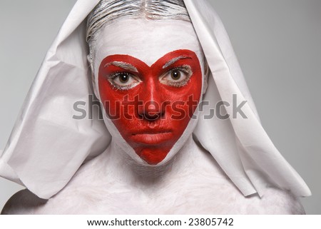 Lovely girl with nun klobuk, red heart shape painted on face