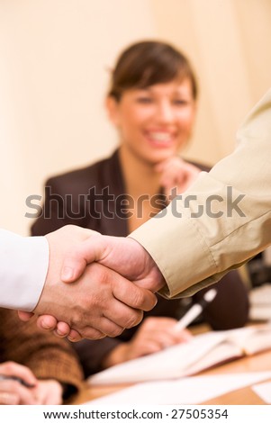 Handshake of business people with female manager at unfocused background