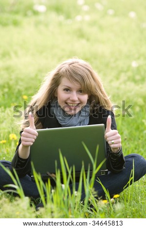 young model with laptop holding thumbs up