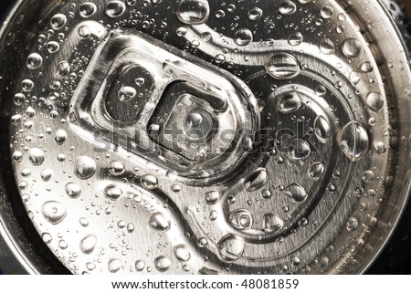 A close up of drink`s tin with drops on steel top