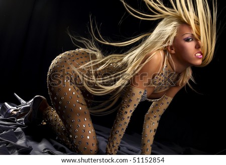 Pretty dancing girl with great fly-away hair in black background