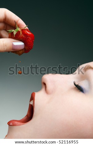 Profile of beautyful girl with strawberry