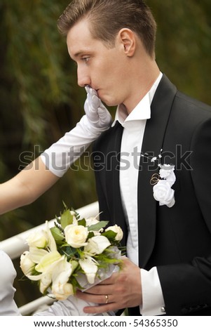Colorful wedding shot of bride shutting groom\'s mouth