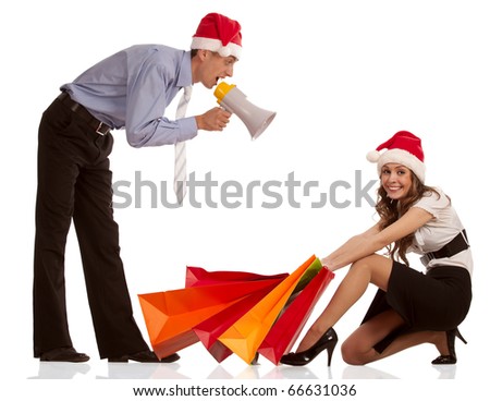 Manager shouting into the megaphone about christmas sale and stylish young woman pulling shopping bags over white background