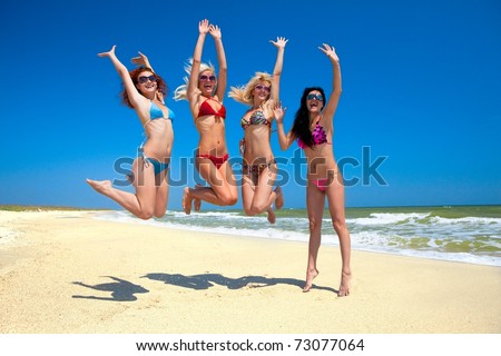 Joyful team of friends having fun at the beach