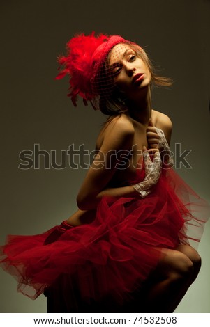 Beautiful sexy woman in red hat with net veil. Retro portrait