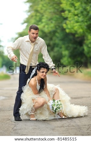 Young wedding couple dance at a park on their wedding day
