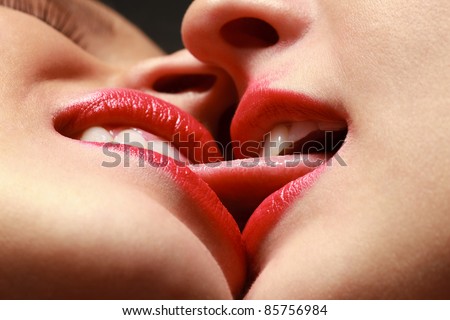Closeup of pair women mouths kissing
