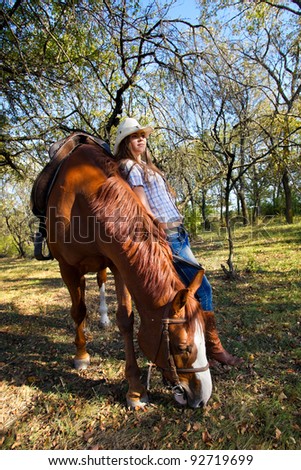 Beautiful girl with a horse in forest