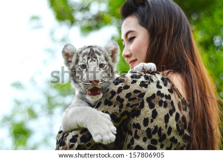 pretty women hold baby white bengal tiger