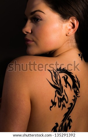 Sexy topless girl with dragon tattoo on her back