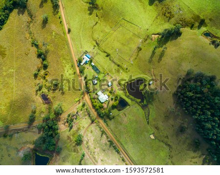 Similar – Image, Stock Photo Aerial view over a little town with wind wheels and a lake in the background of a german countryside.