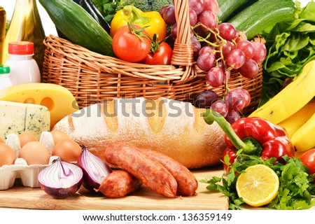 Assorted grocery products including vegetables fruits wine bread dairy and meat